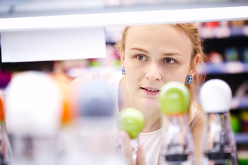 Young woman analyzing products in a store