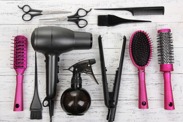 Wall Mural - Hairdressing tools on white wooden table close-up