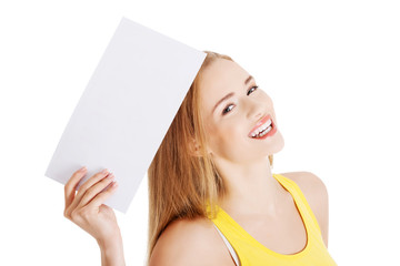 Wall Mural - Attractive casual caucasian woman holds empty white piece of pap