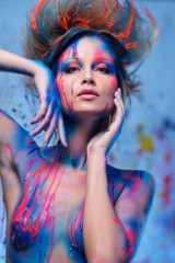 Wall Mural - Young woman muse with creative body art and hairdo