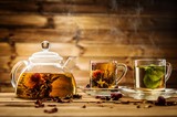 Teapot and glass cups with  tea against wooden background