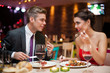 © luckybusiness - man and woman having a romantic meal