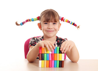 beautiful little girl play with plasticine