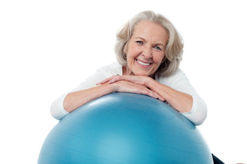 Senior woman posing with exercise ball