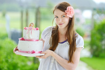 Canvas Print - Young woman holding her birthday cake