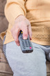 © berna_namoglu - senior hand holding television remote control pressing buttons