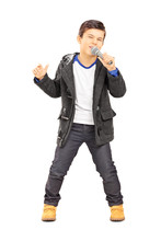 Full Length Portrait Of A Boy Singing On Microphone