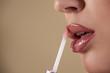 Woman applying lip gloss