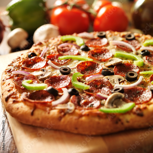 supreme italian pizza with pepperoni and toppings Poster