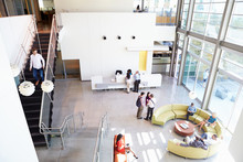 Reception Area Of Modern Office Building With People