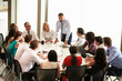 © Monkey Business - Businessman Addressing Meeting Around Boardroom Table