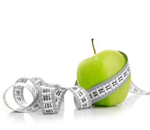 Measuring Tape Wrapped Around A Green Apple