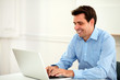 © pablocalvog - Latin 30s entrepreneur working on his laptop