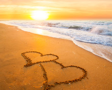 Two Hearts On Beach Sand