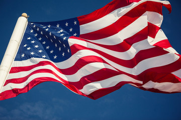 American flag over blue sky