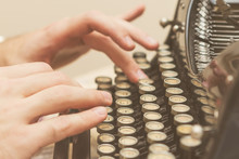 Hands Writing On Old Typewriter