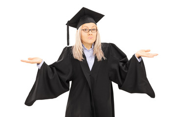 Canvas Print - Confused young female in graduation gown