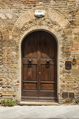 Wall Mural - Closed door of a building in the medieval town of San Gimignano