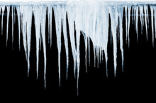 Group Of Icicles Hanging On Black Background
