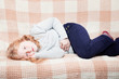 © Maya Kruchancova - child with stomach ache in sofa