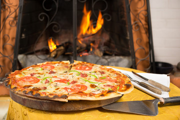 Pizza entering a wood oven