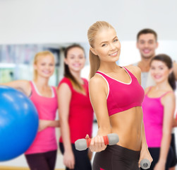 young sporty woman with light dumbbells