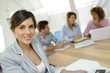 © goodluz - Cheerful young businesswoman in work meeting