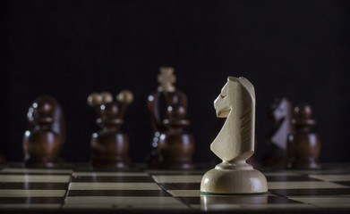 white knight chess piece on the board background