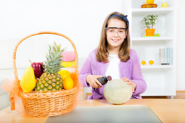 Little girl with grinder and melon