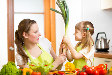 mother and kid  having fun preparing healthy food