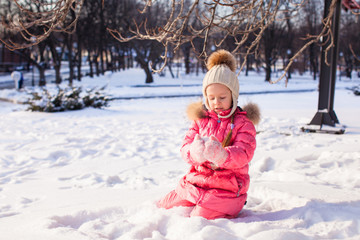 Sticker - Adorable little girl outdoor in the park on a winter day