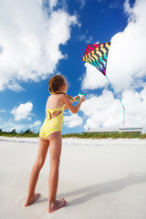 Little girl flying a kite