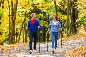 Wall Mural - Nordic walking - active people working out outdoor