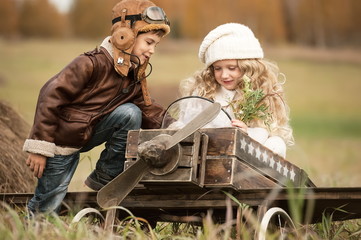 Children with a model airplane field