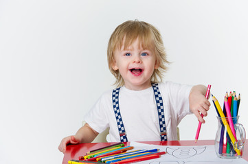 Happy kid drawing colorful paintings with bright pencils