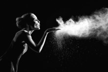 Woman With Stop Motion Of Explosive Powder Captured By Flash