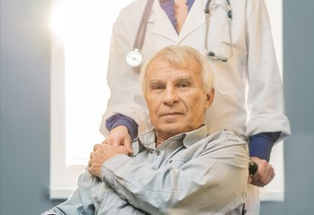 Wall Mural - Nurse woman with senior man in wheelchair