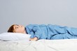 Little boy wearing blue pyjamas in bed