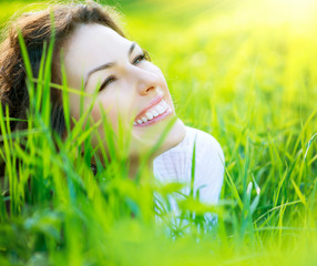 Wall Mural - beautiful spring young woman outdoors enjoying nature