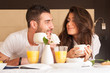 © pio3 - Young couple having breakfast in luxury hotel room.