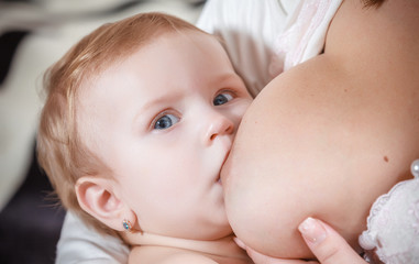 Mother breast feeding newborn baby