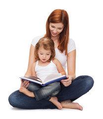 happy mother with adorable little girl and book