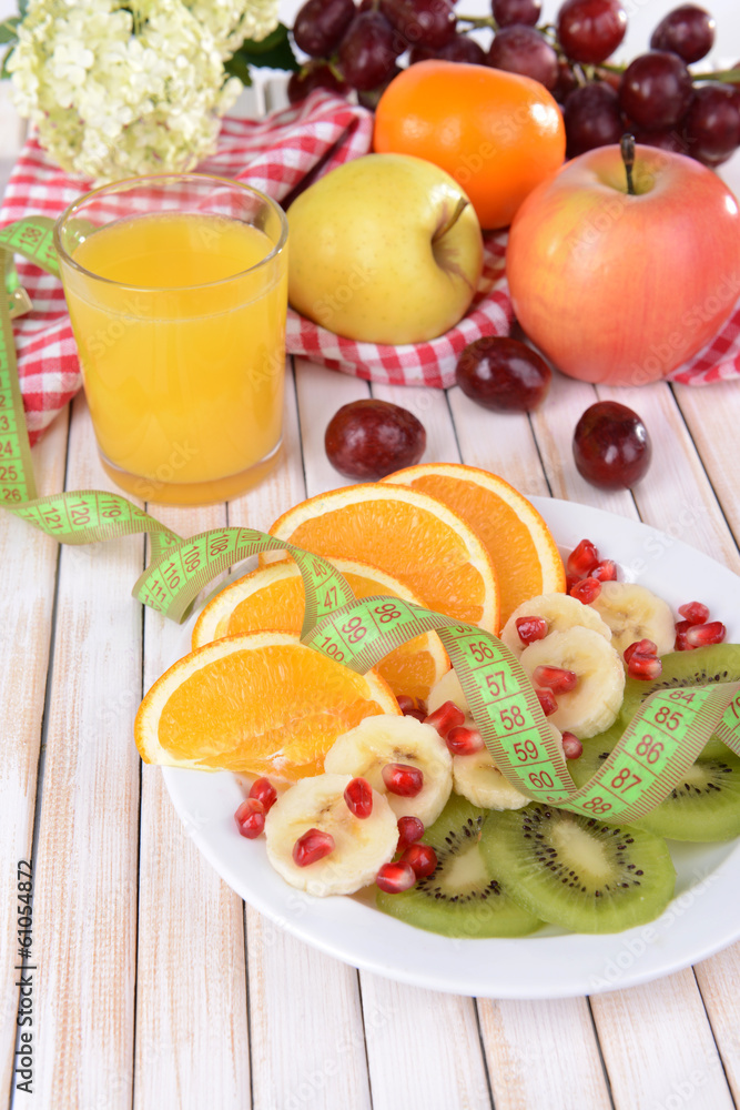 Sweet fresh fruits on plate on table close-up