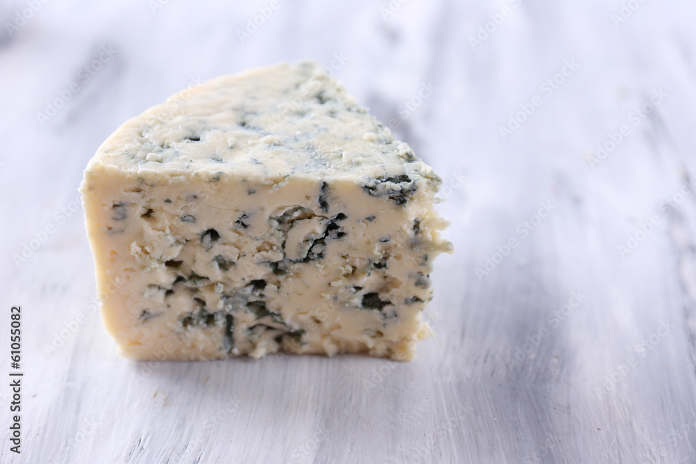 Tasty blue cheese, on wooden table