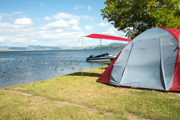 tent on a camping site near a lake