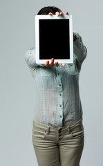 Poster - Woman showing tablet computer screen on gray background