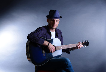 Poster - Young musician playing acoustic guitar and singing,