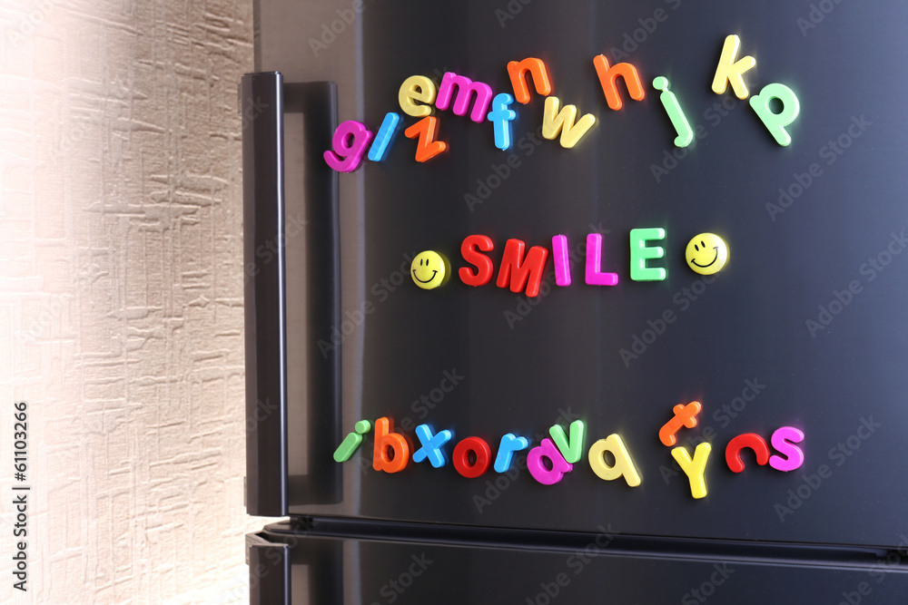Word Smile spelled out using colorful magnetic letters