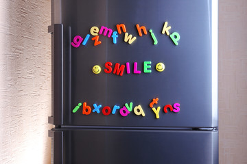 Word Smile spelled out using colorful magnetic letters