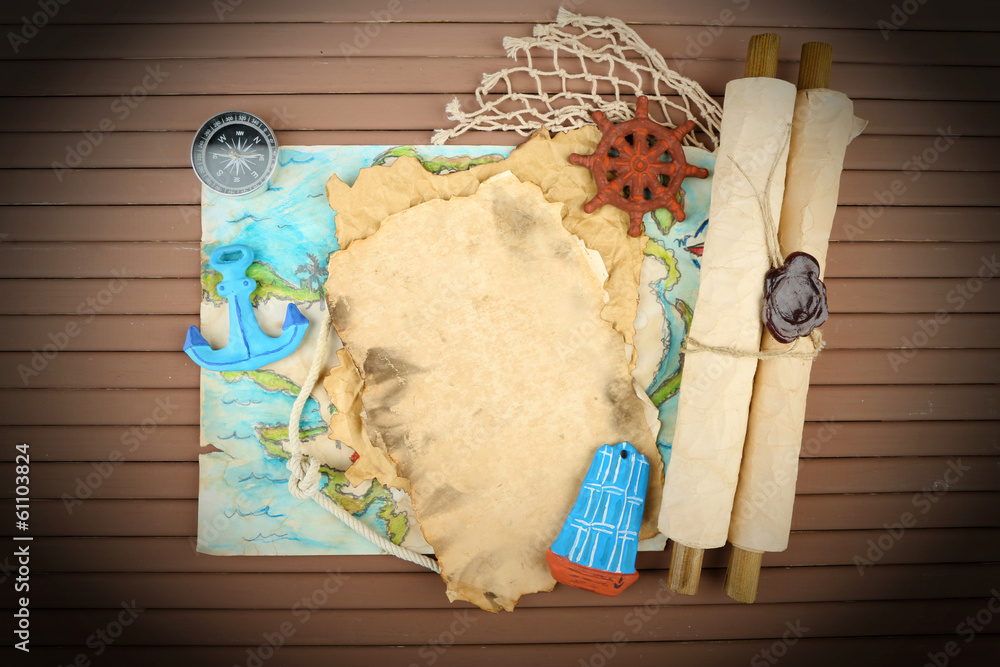 Old paper with sea accessories, isolated on wooden background